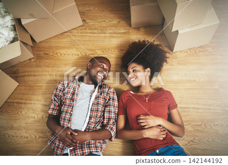 Relax, moving and happy couple on floor in new house with boxes, talking and mortgage with high angle. Smile, black man and woman in home together with future planning, love and property investment Relax, moving and happy couple on floor in new house with boxes, talking and mortgage with high angle. Smile, black man and woman in home together with future planning, love and property investment 142144192