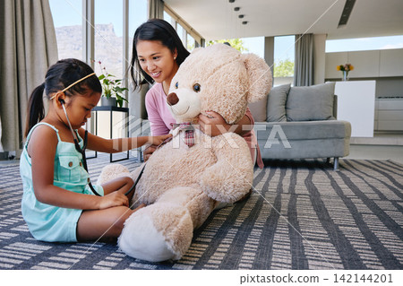 Woman, child and play doctor in house, healthcare and mother in family home with teddy. Girl, stethoscope and learning medical care, heartbeat and education for wellness for childhood development Woman, child and play doctor in house, healthcare and mother in family home with teddy. Girl, stethoscope and learning medical care, heartbeat and education for wellness for childhood development 142144201