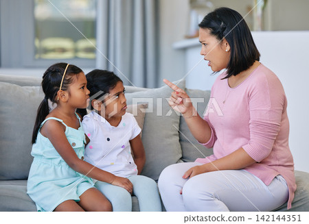 Mother, pointing and scolding children in house, discipline and communication or strict parent in family home. Living room, girl and sofa for punishment or conflict and behaviour, upset and parenting Mother, pointing and scolding children in house, discipline and communication or strict parent in family home. Living room, girl and sofa for punishment or conflict and behaviour, upset and parenting 142144351