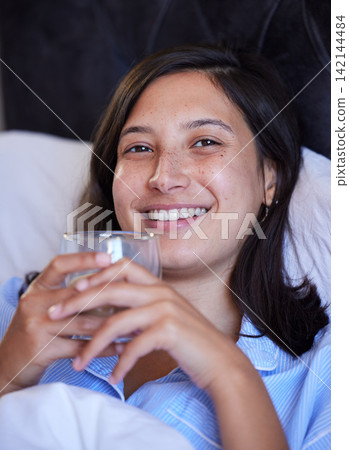 Woman, tea and portrait in bed, night and happy for wellness, hydration or detox for sleep in home. Girl, person and smile in bedroom with coffee for drink, health and digestion on holiday in Naples Woman, tea and portrait in bed, night and happy for wellness, hydration or detox for sleep in home. Girl, person and smile in bedroom with coffee for drink, health and digestion on holiday in Naples 142144484