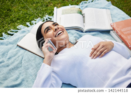 Relax, phone call and girl on grass at campus with blanket, books and happy conversation at university. Education, communication and college student talking on smartphone with outdoor study break. Relax, phone call and girl on grass at campus with blanket, books and happy conversation at university. Education, communication and college student talking on smartphone with outdoor study break. 142144518
