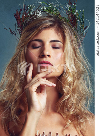 Nature, beauty and creative woman with flowers in crown in hair and glow on skin in studio. Natural, makeup and inspiration from environment in cosmetics or model with floral style in fantasy cosplay Nature, beauty and creative woman with flowers in crown in hair and glow on skin in studio. Natural, makeup and inspiration from environment in cosmetics or model with floral style in fantasy cosplay 142144525