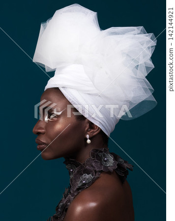 Beauty, fashion and profile of black woman in makeup with headwrap in studio isolated on a blue background. African model, cosmetics and head scarf with serious face for traditional style or thinking Beauty, fashion and profile of black woman in makeup with headwrap in studio isolated on a blue background. African model, cosmetics and head scarf with serious face for traditional style or thinking 142144921