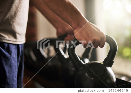Kettlebell, hands and training in gym, fitness and hard work for body builder, strong and muscle of forearm. Workout, exercise and athlete in club, wellness and balance in sports, person with goal Kettlebell, hands and training in gym, fitness and hard work for body builder, strong and muscle of forearm. Workout, exercise and athlete in club, wellness and balance in sports, person with goal 142144949