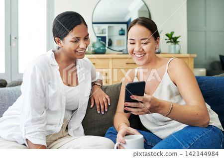 Happy woman, friends and laughing with phone on sofa for social media, communication or funny joke at home. Female person with smile on mobile smartphone for friendly chat or online browsing at house Happy woman, friends and laughing with phone on sofa for social media, communication or funny joke at home. Female person with smile on mobile smartphone for friendly chat or online browsing at house 142144984