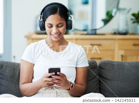 Home, cellphone and woman with headphones, smile and listening to podcast with live streaming music and sound. Apartment, girl and happy person with headset, tech and smartphone with audio and app Home, cellphone and woman with headphones, smile and listening to podcast with live streaming music and sound. Apartment, girl and happy person with headset, tech and smartphone with audio and app 142145011