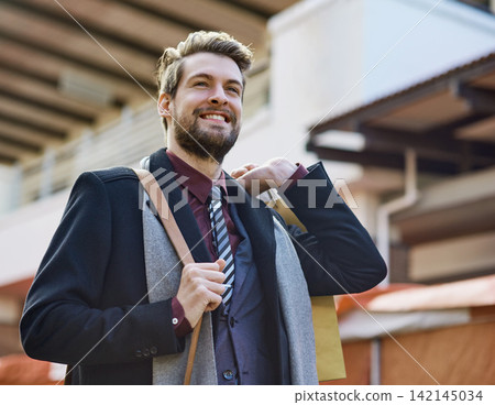 Businessman, happy and shopping in city for fashion, style and clothes with bag in street. Male person, smile and thrifting in New York for weekend, work and suit for interview in urban area Businessman, happy and shopping in city for fashion, style and clothes with bag in street. Male person, smile and thrifting in New York for weekend, work and suit for interview in urban area 142145034