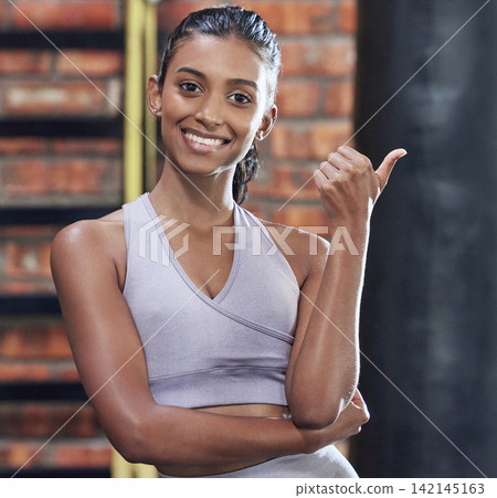 Woman, gym and thumbs up for fitness with sport for health, wellness and training by boxing exercise. Happy, active and female athlete with gesture in portrait for motivation or support with goals Woman, gym and thumbs up for fitness with sport for health, wellness and training by boxing exercise. Happy, active and female athlete with gesture in portrait for motivation or support with goals 142145163