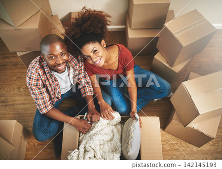Portrait, boxes and black couple on floor in new home with moving, smile and mortgage with top view. Relax, man and happy woman in apartment together with packing, love and property investment. Portrait, boxes and black couple on floor in new home with moving, smile and mortgage with top view. Relax, man and happy woman in apartment together with packing, love and property investment. 142145193