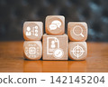 Visual representation of AI-driven talent acquisition using digital icons on wooden blocks, symbolizing modern recruitment strategies. 142145204