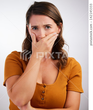 Woman, portrait and shocked with bad news, secret or scary story on a gray studio background. Female person with hand on mouth in shock, OMG or wtf for alert, surprise rumor or gasp from announcement Woman, portrait and shocked with bad news, secret or scary story on a gray studio background. Female person with hand on mouth in shock, OMG or wtf for alert, surprise rumor or gasp from announcement 142145333