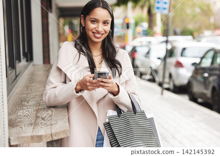 Woman, portrait and phone with shopping bags, street and love for retail boutique product. Customer, mall and happiness for valentine gift, sale and discount with fashion present and service purchase Woman, portrait and phone with shopping bags, street and love for retail boutique product. Customer, mall and happiness for valentine gift, sale and discount with fashion present and service purchase 142145392