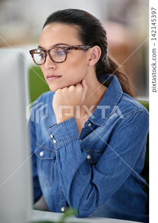 Computer, woman and desk for online work, thinking and read on internet in workspace. Technology, employee and creative for freelancer web designer, research and editing for agency or business Computer, woman and desk for online work, thinking and read on internet in workspace. Technology, employee and creative for freelancer web designer, research and editing for agency or business 142145397