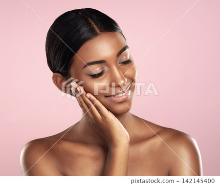 Woman, studio and beauty with glow, skincare and cosmetics with satisfaction and confidence. Model, aesthetic or body care for natural, clean skin and detox for self love isolated on pink background Woman, studio and beauty with glow, skincare and cosmetics with satisfaction and confidence. Model, aesthetic or body care for natural, clean skin and detox for self love isolated on pink background 142145400
