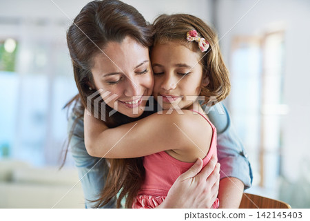 Face, calm mother and girl hug for support in home for care, safety and bonding together to relax. Smile, love and proud single parent mom with kid for security, daughter or child in family house Face, calm mother and girl hug for support in home for care, safety and bonding together to relax. Smile, love and proud single parent mom with kid for security, daughter or child in family house 142145403