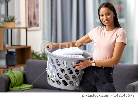 Cleaning, laundry and portrait of girl with basket in home or cleaner working with happiness. Washing, clothes and maid with fresh linen in hotel, hospitality service or help with chores in apartment Cleaning, laundry and portrait of girl with basket in home or cleaner working with happiness. Washing, clothes and maid with fresh linen in hotel, hospitality service or help with chores in apartment 142145572