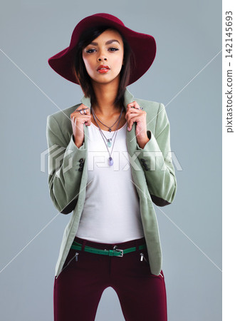 Woman. fashion and portrait with y2k style and chic clothes in a studio with confidence. Trendy, clothing and young designer student from Houston with smart casual outfit and grey background Woman. fashion and portrait with y2k style and chic clothes in a studio with confidence. Trendy, clothing and young designer student from Houston with smart casual outfit and grey background 142145693