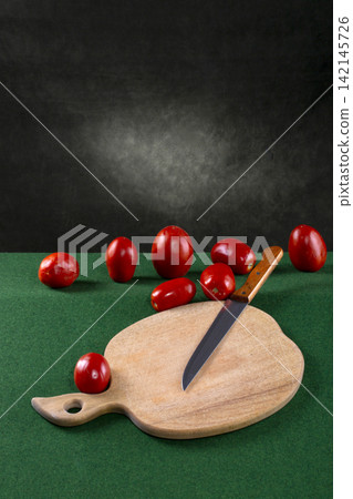 Ripe red tomatoes with a knife and a cutting wooden board Ripe red tomatoes with a knife and a cutting wooden board 142145726