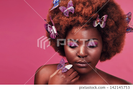Beauty, face and black woman with butterflies in studio with creative, art and fairy fantasy. Cosmetics, makeup and female model from Nigeria with insects for facial cosmetology by pink background. Beauty, face and black woman with butterflies in studio with creative, art and fairy fantasy. Cosmetics, makeup and female model from Nigeria with insects for facial cosmetology by pink background. 142145753