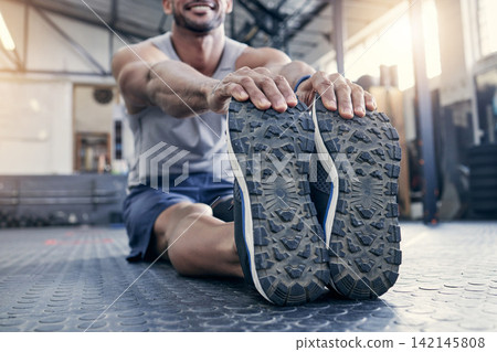 Fitness, feet and man with stretching at gym for exercise, preparation and performance on floor. Health club, training and legs of male person with warm up for flexibility, workout and cardio energy Fitness, feet and man with stretching at gym for exercise, preparation and performance on floor. Health club, training and legs of male person with warm up for flexibility, workout and cardio energy 142145808