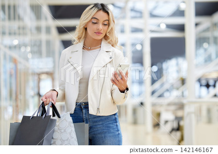 Shopping bag, phone or woman on social media in mall to search for bargain notification or texting online. Retail, fashion deal and female customer on mobile app for chat, meme and website sale code Shopping bag, phone or woman on social media in mall to search for bargain notification or texting online. Retail, fashion deal and female customer on mobile app for chat, meme and website sale code 142146167