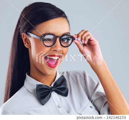 Happiness, girl and wink with glasses for fashion in studio for designer, flirting and quirky on backdrop. Gen z, stylish and aesthetic portrait of young woman for trendy, sunglasses, and clothing. Happiness, girl and wink with glasses for fashion in studio for designer, flirting and quirky on backdrop. Gen z, stylish and aesthetic portrait of young woman for trendy, sunglasses, and clothing. 142146233