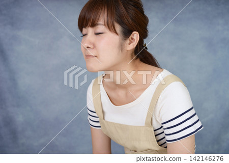 Housewife with tired expression Housewife with tired expression 142146276