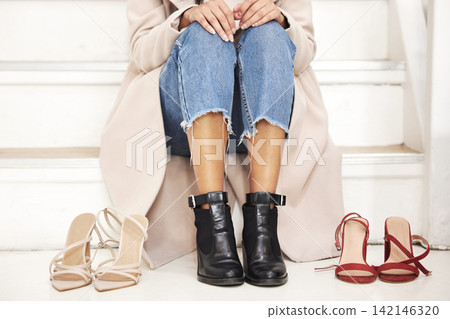 Woman, legs and heels with pair for choice, decision or selection on stairs or floor at shopping mall. Closeup of female person, customer or shopper trying on shoes for feet size, fashion or comfort Woman, legs and heels with pair for choice, decision or selection on stairs or floor at shopping mall. Closeup of female person, customer or shopper trying on shoes for feet size, fashion or comfort 142146320