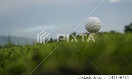 Golf ball on tee in a beautiful golf course with morning sunshine. Golf ball on tee in a beautiful golf course with morning sunshine. 142146713