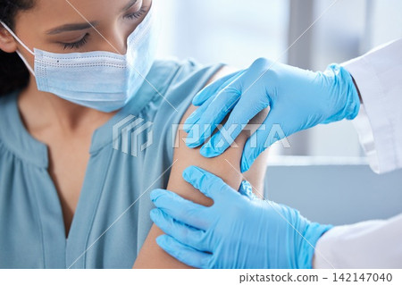 Patient, face mask and doctor hands for injection of virus cure for vaccination, pandemic or immunity. Person, arm and gloves in hospital with ppe protection for .Influenza bacteria, safety or shot Patient, face mask and doctor hands for injection of virus cure for vaccination, pandemic or immunity. Person, arm and gloves in hospital with ppe protection for .Influenza bacteria, safety or shot 142147040