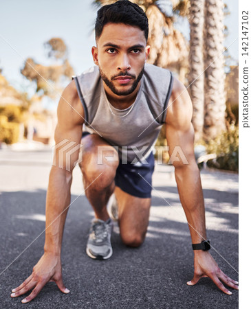 Man, runner and start line for sport, fitness and exercise in race or competition on road or street. Serious, male athlete, and ready to start running for marathon training and muscle development Man, runner and start line for sport, fitness and exercise in race or competition on road or street. Serious, male athlete, and ready to start running for marathon training and muscle development 142147102