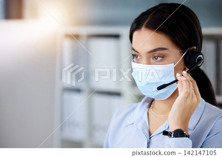 Face mask, call center and woman consultant in office for online crm consultation with virus. Safety, contact us and agent with headset for telemarketing, technical support or customer service job. 142147105