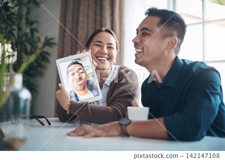 Couple of friends, video call and tablet screen with people laughing in living room of home together. Face, funny or humor with happy young man and woman in apartment for communication or online chat Couple of friends, video call and tablet screen with people laughing in living room of home together. Face, funny or humor with happy young man and woman in apartment for communication or online chat 142147108