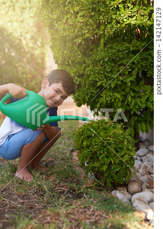 Child, water plant and portrait in garden for learning responsibility and development. Young boy, kid or children and smile for gardening outdoor, happy, independent or childhood on grass for play 142147129