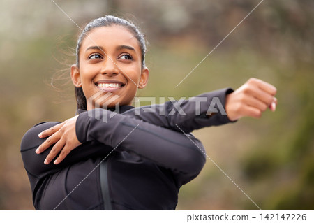 Fitness, smile and woman stretching arms in park for running exercise, wellness or marathon training in nature. Sports, cardio and Indian girl runner in forest with body, warm up and routine workout Fitness, smile and woman stretching arms in park for running exercise, wellness or marathon training in nature. Sports, cardio and Indian girl runner in forest with body, warm up and routine workout 142147226