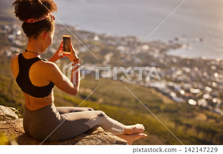 Mountain, fitness and phone for picture with woman to relax from exercise, training and workout of hiking. Healthy, female person and cliff for photography of scenic view with smartphone for memory Mountain, fitness and phone for picture with woman to relax from exercise, training and workout of hiking. Healthy, female person and cliff for photography of scenic view with smartphone for memory 142147229