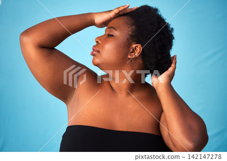 Black woman, studio or hair care with natural or hands for aesthetics, afro with positivity for wellness. Female person, blue background or glow with hairstyle for cosmetic, confidence with plus size Black woman, studio or hair care with natural or hands for aesthetics, afro with positivity for wellness. Female person, blue background or glow with hairstyle for cosmetic, confidence with plus size 142147278