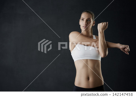 Woman, stretch and arms for fitness in studio for health training or workout as athlete runner for marathon competition. Active, female person and sports for strong muscle or achievement of goal 142147458