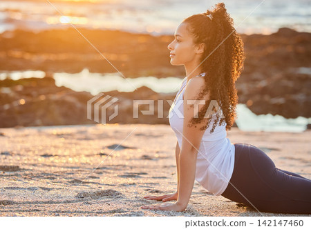 Beach, sunset and woman with stretching in yoga for muscle relief, balance or mindfulness. Healthy workout, zen and female person with cobra exercise for flexibility, chakra healing and awareness Beach, sunset and woman with stretching in yoga for muscle relief, balance or mindfulness. Healthy workout, zen and female person with cobra exercise for flexibility, chakra healing and awareness 142147460
