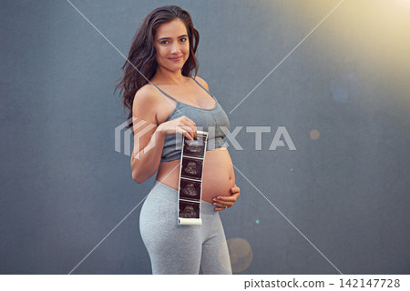 Studio, pregnancy and woman in portrait with ultrasound picture of baby, infant or results of child. Pregnant person, scan and happiness with mockup space, news and excited on gray background Studio, pregnancy and woman in portrait with ultrasound picture of baby, infant or results of child. Pregnant person, scan and happiness with mockup space, news and excited on gray background 142147728