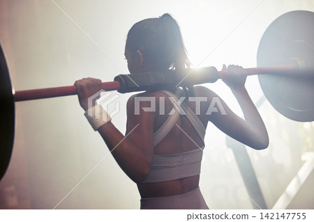 Barbell, gym and woman for workout and wellness, challenge and empowerment goal for body health. Athlete, training and Indian bodybuilder in fitness club for self care, squats for legs exercise Barbell, gym and woman for workout and wellness, challenge and empowerment goal for body health. Athlete, training and Indian bodybuilder in fitness club for self care, squats for legs exercise 142147755