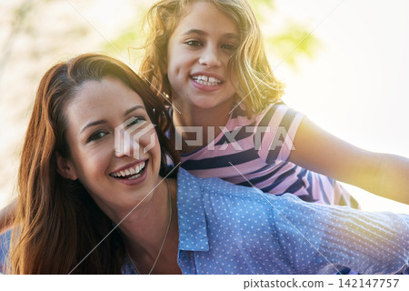 Mom, girl and piggyback in portrait for outdoor games, excited and fun in sun for bonding, love and support. Happy family or parent playing with child for mothers day in nature or park for adventure Mom, girl and piggyback in portrait for outdoor games, excited and fun in sun for bonding, love and support. Happy family or parent playing with child for mothers day in nature or park for adventure 142147757
