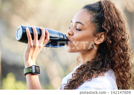 Woman, hiking and drinking or water bottle in nature for exercise hydration, trekking or workout. Female person, latino and mountain path or running cardio for fitness triathlon, journey or health Woman, hiking and drinking or water bottle in nature for exercise hydration, trekking or workout. Female person, latino and mountain path or running cardio for fitness triathlon, journey or health 142147809