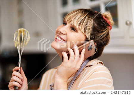 Phone call, bakery and happy woman with whisk in kitchen for food service, cake order or delivery. Small business, smile and baker talking to customer for startup, communication or conversation Phone call, bakery and happy woman with whisk in kitchen for food service, cake order or delivery. Small business, smile and baker talking to customer for startup, communication or conversation 142147815