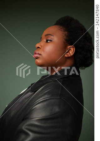 Studio, black girl and thinking by green background of fashion ideas, planning and pride. Female model, profile and stylish with casual outfit, organic cotton or leather for cool or trendy look Studio, black girl and thinking by green background of fashion ideas, planning and pride. Female model, profile and stylish with casual outfit, organic cotton or leather for cool or trendy look 142147840