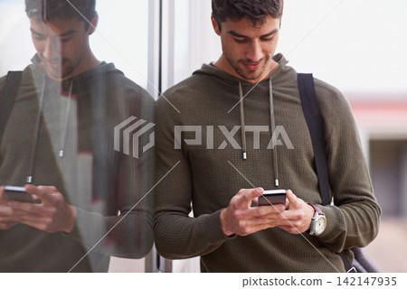 Outdoor, smartphone and man in window reflection, texting and social media for student on campus. Technology, cellphone for scroll for male learner, internet or conversation online for entertainment Outdoor, smartphone and man in window reflection, texting and social media for student on campus. Technology, cellphone for scroll for male learner, internet or conversation online for entertainment 142147935