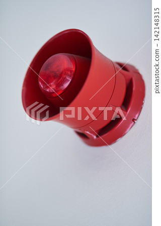 Emergency, siren and red speaker for fire alarm, warning and evacuation with safety regulations or compliance. Light on wall for security alert, noise and danger with sound, electricity and risk Emergency, siren and red speaker for fire alarm, warning and evacuation with safety regulations or compliance. Light on wall for security alert, noise and danger with sound, electricity and risk 142148315
