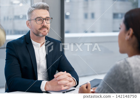 Office, interview and mature man in meeting as human resources, recruitment and contract negotiation. Professional, boss and listening to person with resume, CV and discussion of onboarding or hiring Office, interview and mature man in meeting as human resources, recruitment and contract negotiation. Professional, boss and listening to person with resume, CV and discussion of onboarding or hiring 142148750