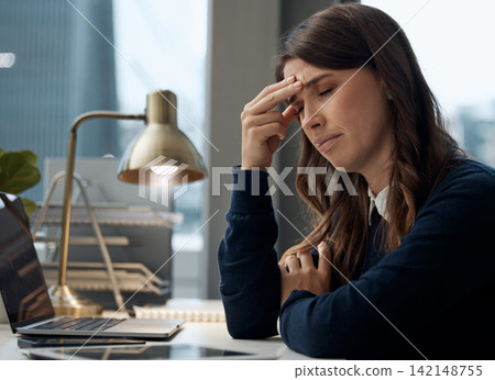 Woman, tired and headache by laptop in office with pressure for audit deadline, anxiety and migraine. Finance, desk and accountant with tension by tech for burnout, problem and exhausted at work 142148755