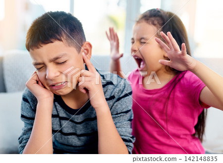 Siblings, screaming and angry with fight in home for conflict, problem and frustrated on sofa. Boy, finger in ears and girl with tantrum in living room for dispute, upset and shouting in argument Siblings, screaming and angry with fight in home for conflict, problem and frustrated on sofa. Boy, finger in ears and girl with tantrum in living room for dispute, upset and shouting in argument 142148835